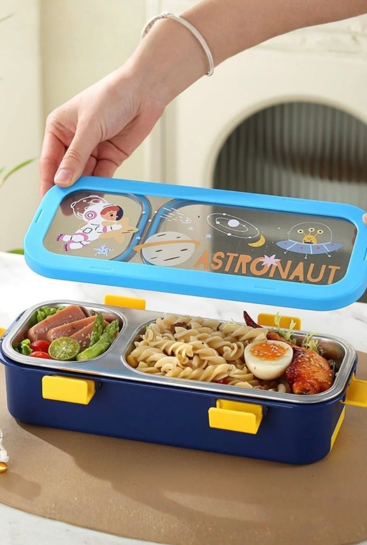 Kids lunch box open showing steel inner with 2 compartments of food