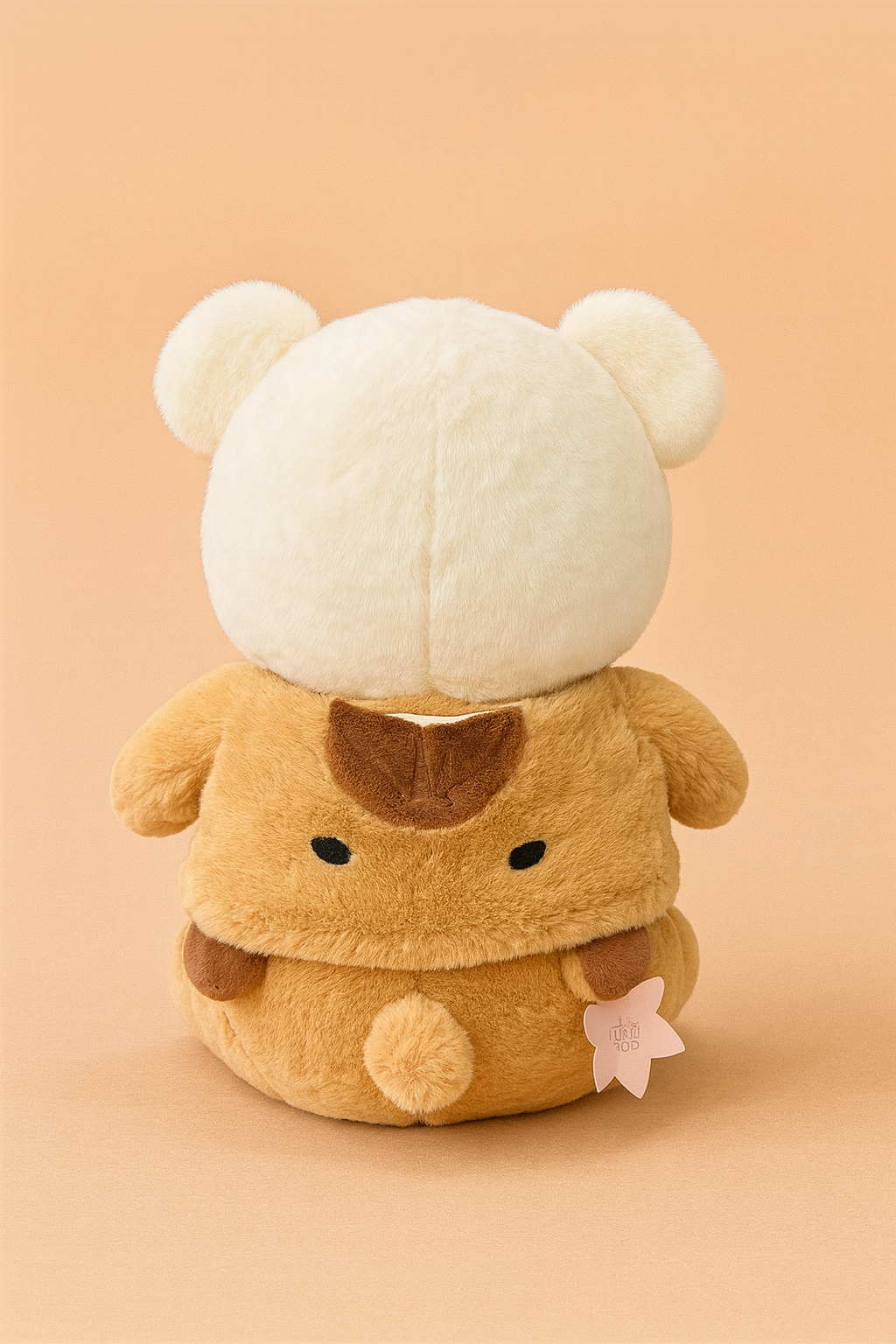 Plush toy with a white head and brown body on a beige background